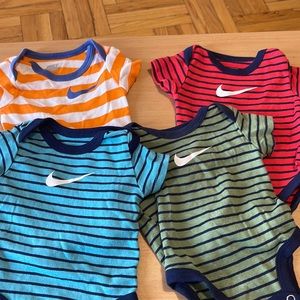 Baby four pack Nike onesies